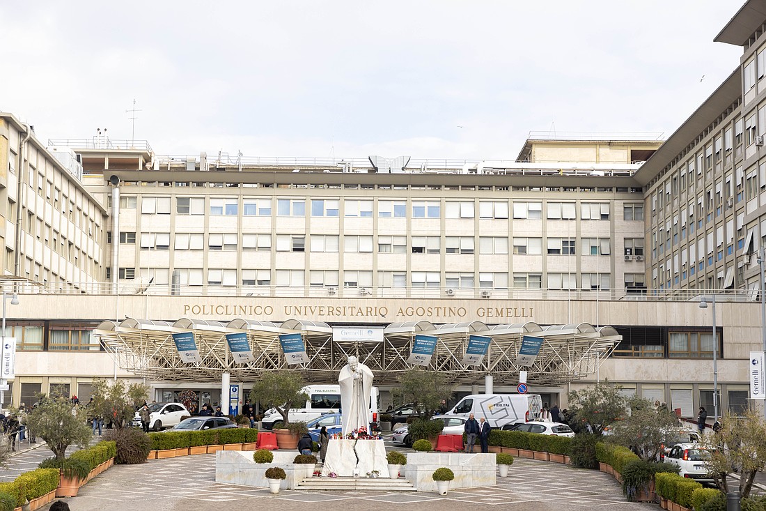 A statue of St. John Paul II stands outside the main entrance of Rome's Gemelli hospital Feb. 18, 2025. Pope Francis has been an inpatient at the hospital since Feb. 14. (CNS photo/Pablo Esparza)