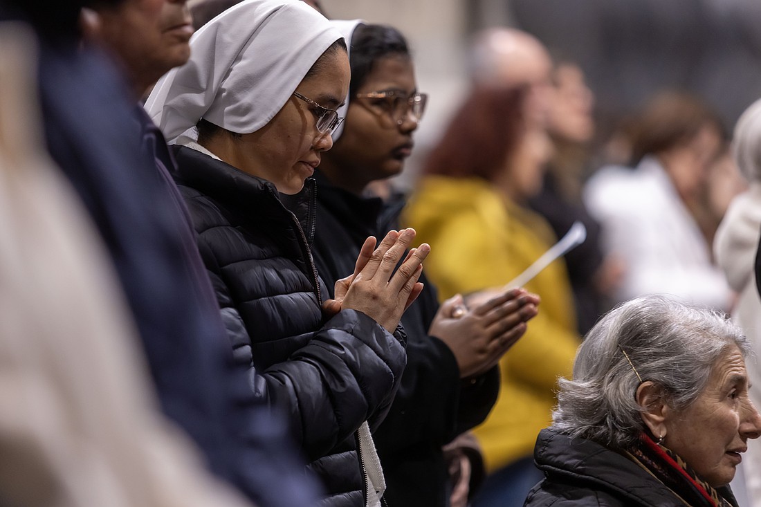 People pray for the ailing Pope Francis during a special evening Mass Feb. 23, 2025, in Rome's Basilica of St. John Lateran. (CNS photo/Pablo Esparza)