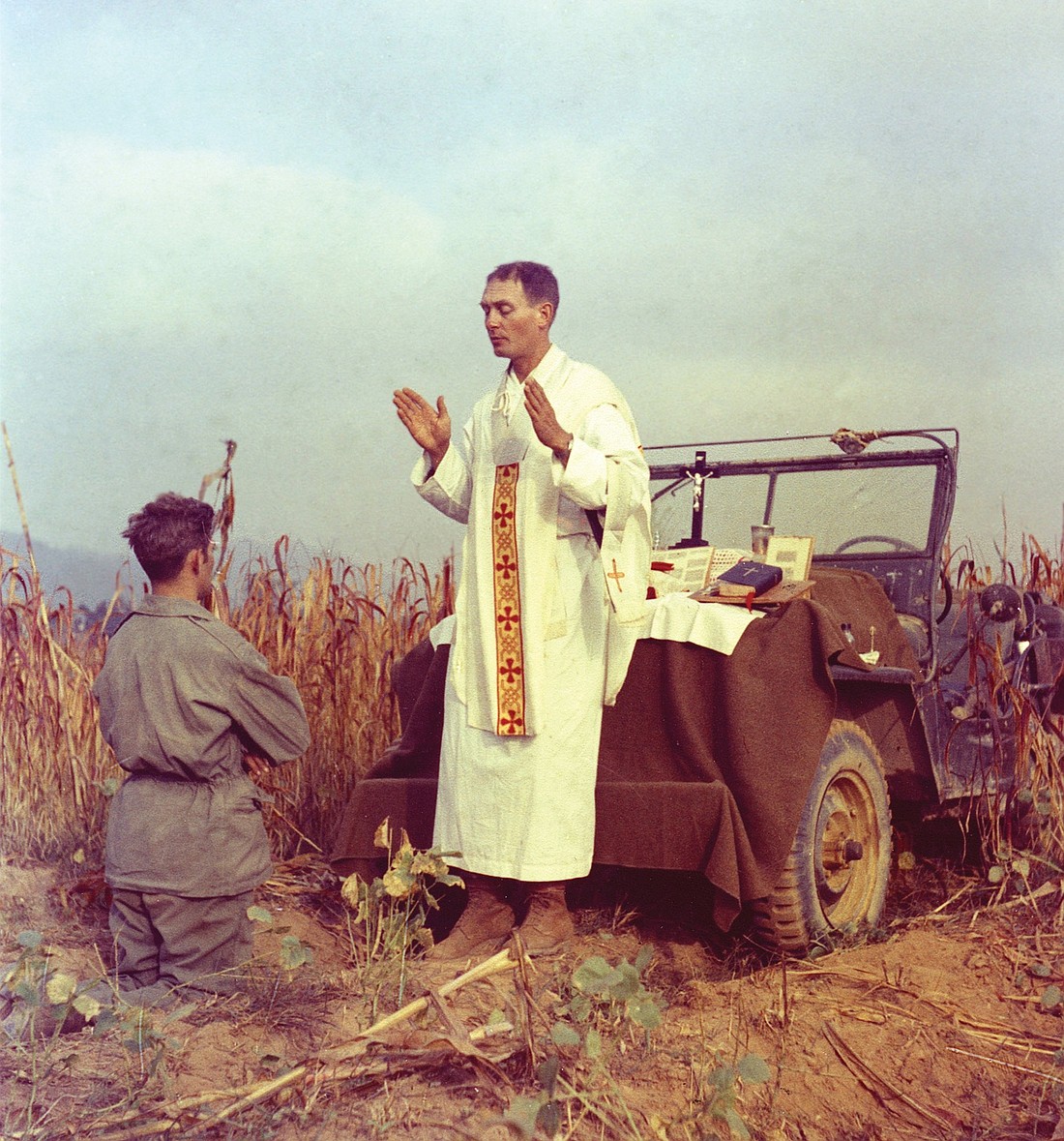 Father Emil Joseph Kapaun, a U.S. Army chaplain, is pictured celebrating Mass from the hood of a jeep Oct. 7, 1950, in South Korea. A candidate for sainthood, he died May 23, 1951, in a North Korean prisoner of war camp. (CNS photo/courtesy U.S. Army medic Raymond Skeehan)
