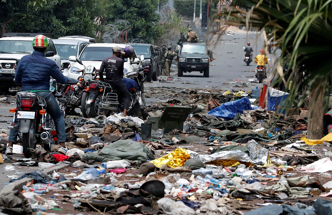 People on motorcycles look at military uniforms and ammunition from the armed forces of the Democratic Republic of the Congo (FARDC) lying on the ground in Goma, Congo, Jan. 30, 2025, amid clashes between them and the M23 rebels. (OSV News photo/Reuters)