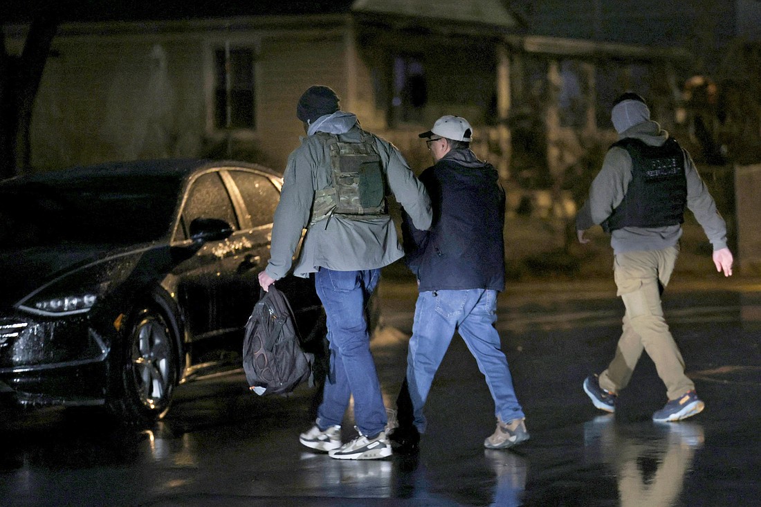 Federal officers carrying out U.S. immigration enforcement near Rockville, Md., Feb. 6, 2025, prepare a Filipino man for transport to a U.S. Immigration and Customs Enforcement office for processing. The man had entered the U.S. legally but violated the terms of his status when he pleaded guilty to sex abuse of two children, according to ICE and court documents. The man was a lawful permanent resident, said an attorney who represented him in the sex abuse case. "He is now facing deportation and has accepted responsibility for this case," he said. (OSV News photo/Leah Millis, Reuters)