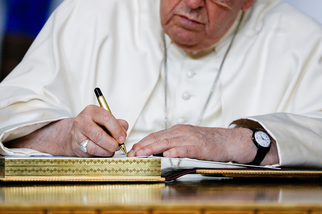 Pope Francis signs the guest book after a meeting with Mongolia's president in the State Palace in Ulaanbaatar, Mongolia, Sept. 2, 2023. (CNS photo/Lola Gomez)