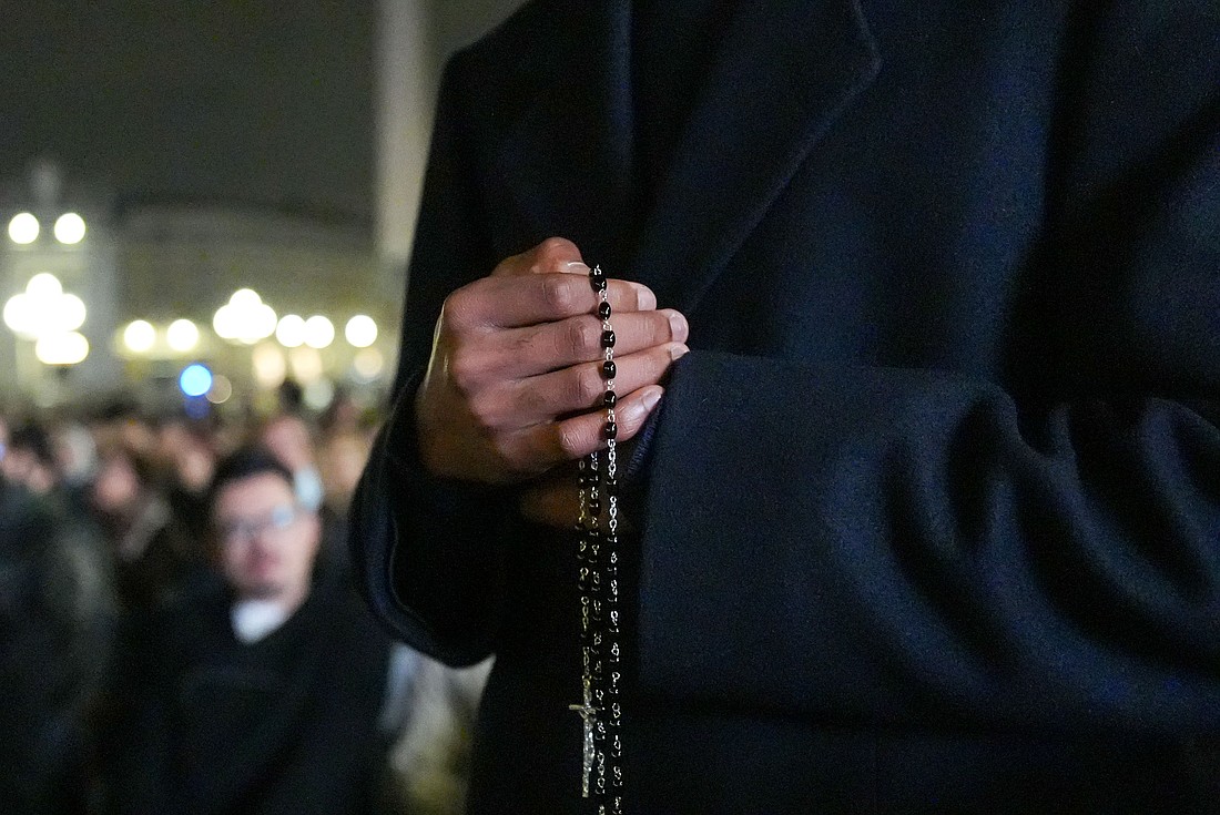 A priest holds a rosary as he joins Cardinal Luis Antonio Tagle, pro-prefect of the Dicastery for Evangelization, cardinals living in Rome, officials of the Roman Curia and other faithful in praying for Pope Francis Feb. 25, 2025, in St. Peter's Square at the Vatican. (CNS photo/Lola Gomez)