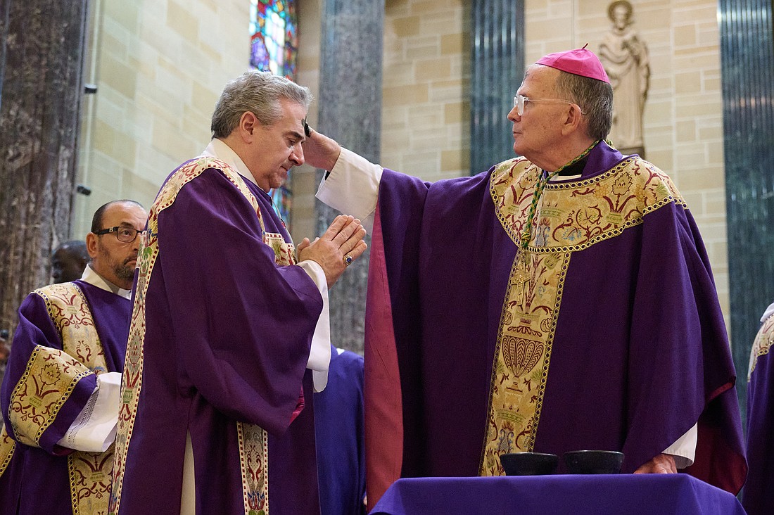 Bishop O'Connell imposes ashes on the heads of clergy in St. Mary of the Assumption Cathedral, Trenton, one of three locations where he celebrated Mass on Ash Wednesday. Mike Ehrmann photo