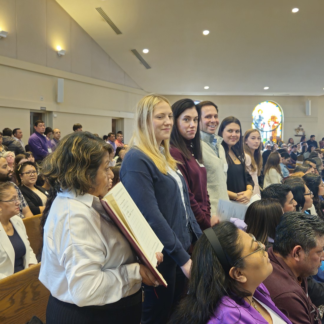 Catechumens, along with their godparents, stand during the Rite of Election ceremony celebrated by Bishop O'Connell.