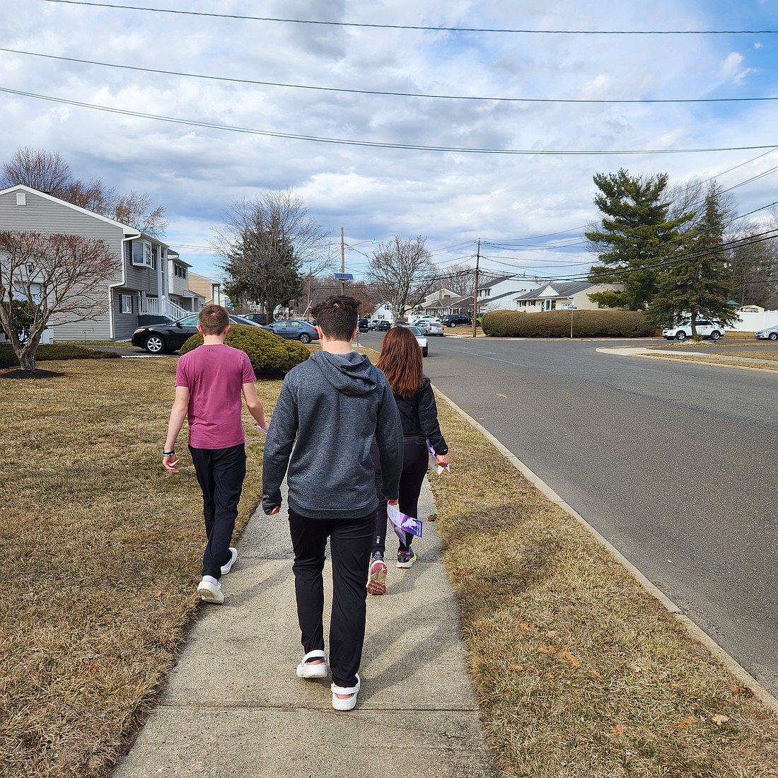 Parishioners travel through a Hamilton Square neighborhood, ready to place door hangers containing information on events in St. Gregory the Great Parish.