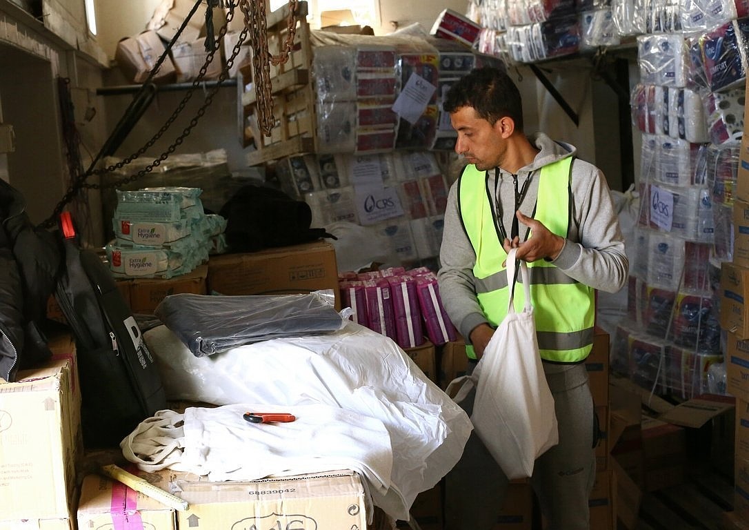 A humanitarian aid worker is pictured in a file photo packing Catholic Relief Services relief supplies in Rafah, in the southern Gaza Strip, for distribution to people displaced in war-torn Gaza. (OSV News photo/Mohammad Al Hout for CRS)