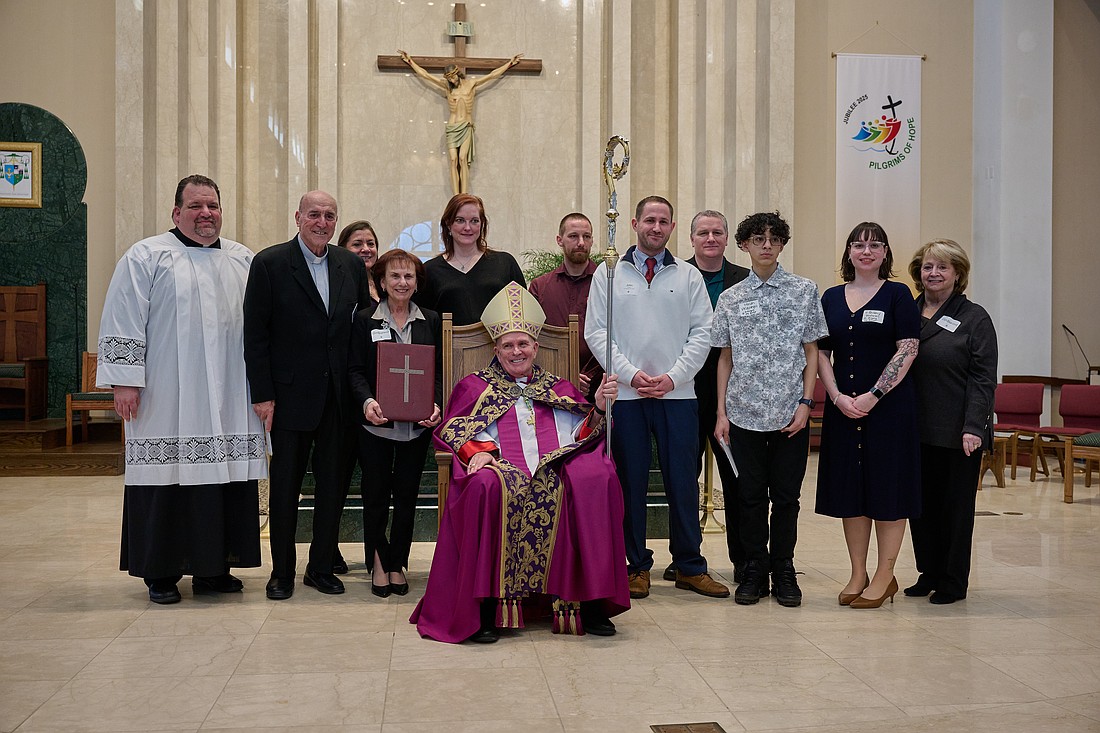 Father Michael Hall, pastor of St. Gregory the Great Parish, Hamilton Square, the parish OCIA team and elect pose for a photo with Bishop O'Connell following Rite of Election. Mike Ehrmann photo