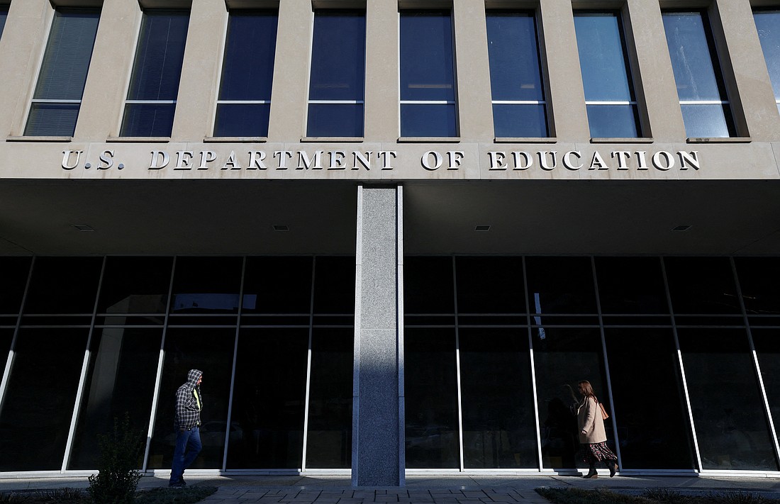People walk in front of the Department of Education building  in Washington Feb. 4, 2025, amid reports that President Donald Trump's administration will take steps to defund the federal Education Department. The Department of Education said March 11 it planned to cut about 50% of its workforce. Such cuts could also impact Catholic education, experts told OSV News. (OSV news photo/Kevin Lamarque, Reuters)