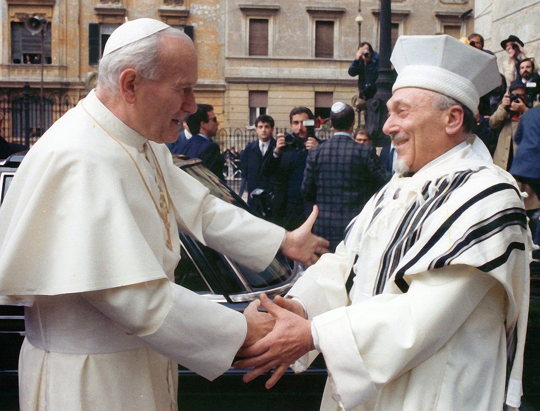 St. John Paul II greets Rabbi Elio Toaff in 1986 at Rome's main synagogue, believed to be the oldest Jewish community in the West. Their historic April 13, 1986, meeting marked the beginning of a new period in Catholic-Jewish relations. (CNS file photo/Arturo Mari, L'Osservatore Romano)