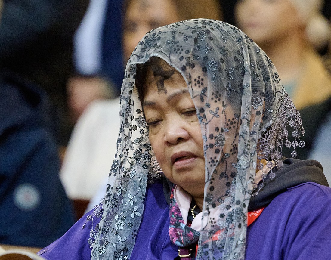 A woman solemnly prays during the Ash Wednesday Mass celebrated by Bishop David M. O'Connell, C.M., in St. Mary of the Assumption Cathedral, Trenton. The Lenten season is a time for all the faithful to be spiritually renewed as they carry out the three pillars of Prayer, Fasting and Almsgiving. Mike Ehrmann photo