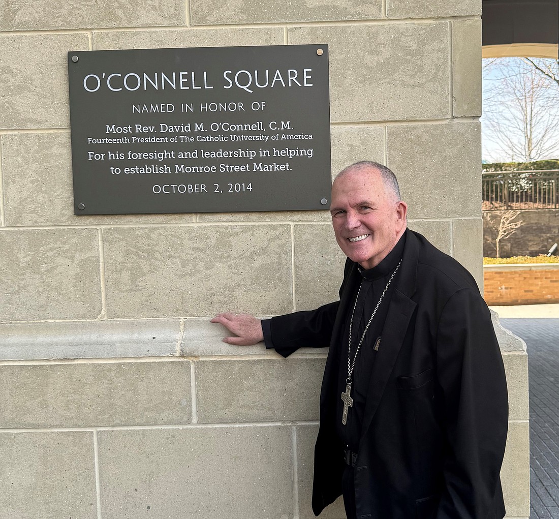 Bishop O'Connell stands by the plaque in O'Connell Square which was dedicated in his name in 2014. Staff photo