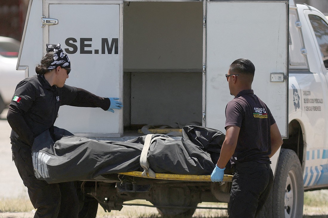 Forensic technicians collect the body of a person who was murdered and burned by unknown assailants at a park in Ciudad Juarez, Mexico, May 27, 2024, according to local media. In a March 12 statement, The Mexican bishops' conference expressed outrage over the discovery of an extermination camp operated by a drug cartel, calling it "one of the cruelest expressions of evil and human misery that we've seen in the country," and alleging such sites exist in other parts of Mexico. (OSV News photo/Jose Luis Gonzalez, Reuters)