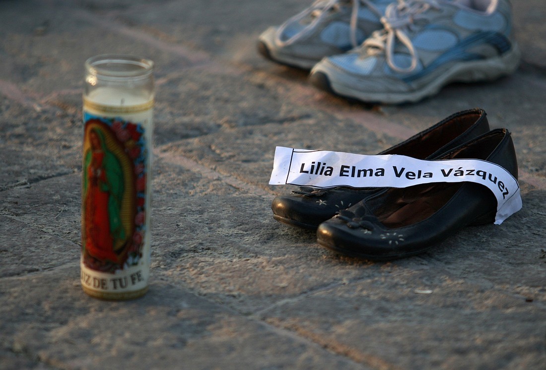 A a file photo in Monterrey, Mexico, shows a candle with an image of Our Lady of Guadalupe and pairs of shoes with a name tag of its owner, a victim of the drug war. In a statement shared March 12, 2025 the Mexican bishops' conference expressed outrage over the discovery of an extermination camp operated by a drug cartel, calling it "one of the cruelest expressions of evil and human misery that we've seen in the country," and alleging such sites exist in other parts of Mexico. (OSV News photo/Daniel Becerril, Reuters)