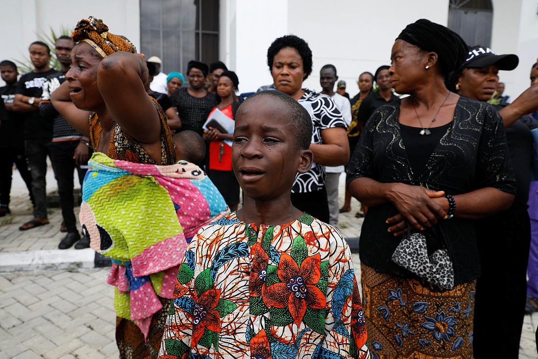 A woman and child cry following a funeral Mass in the parish hall of St. Francis Xavier Church in Owo, Nigeria, June 17, 2022. The Mass was for some of the 40 victims killed in an attack on June 5 of that year by gunmen during Mass at the church. Over the last 14 years, 52,250 people in Nigeria have been killed merely for being Christians, according to a report published April 10, 2023. (OSV News photo/Temilade Adelaja, Reuters)