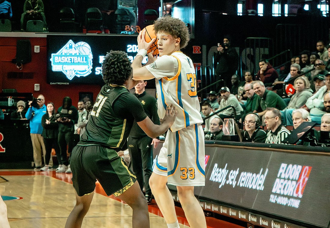 Belmar's St. Rose guard Jayden Hodge, who led had a game-high 23 points and 12 rebounds, looks for someone to pass to while being guarded by Roselle Catholic's Trevon Lewis. Matthew Lyman photo/@Matt_L_Flics