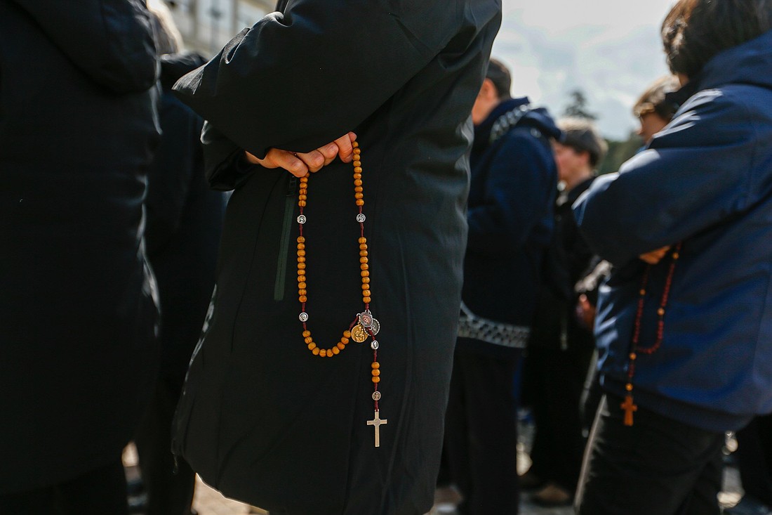 People pray the rosary outside of Pope Francis' hospital room at Rome's Gemelli hospital March 16, 2025. (CNS photo/Justin McLellan)