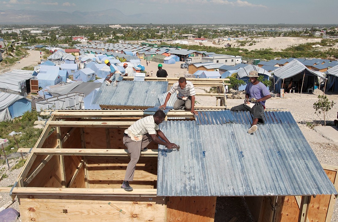 Workers at a camp in Terrain Toto, Haiti, construct transitional shelters provided by Catholic Relief Services for those left homeless in the 2010 earthquake. CRS, the overseas charitable arm of the Catholic Church in the U.S., urged the Trump administration March 17, 2025, to issue prompt payments for life-saving foreign aid work. (OSV News photo/CNS file, Bob Roller)