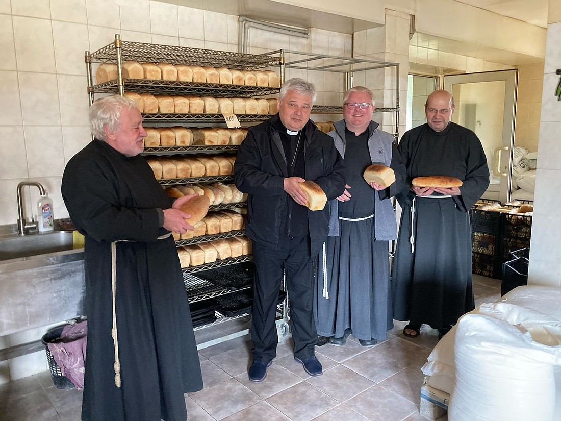 The papal point man on charity, Cardinal Konrad Krajewski, is seen in the bakery where Albertine brothers pictured with him bake bread for the needy population, in Zaporizhzhia, eastern Ukraine, on April 8, 2025. The Albertine brothers carry the charism of St. Brother Albert, a Polish friar who tended to the homeless and poor in the late 19th and early 20th century. (OSV News/courtesy Bishop Jan Sobilo)