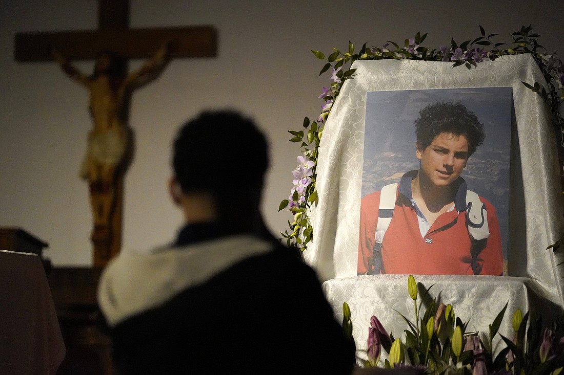 A boy kneels in prayer before an image of Blessed Carlo Acutis during eucharistic adoration April 7, 2022, at St. Rita of Cascia Church in the South Bronx, N.Y. Blessed Carlo will be canonized April 27, 2025. (OSV News photo/Gregory A. Shemitz)