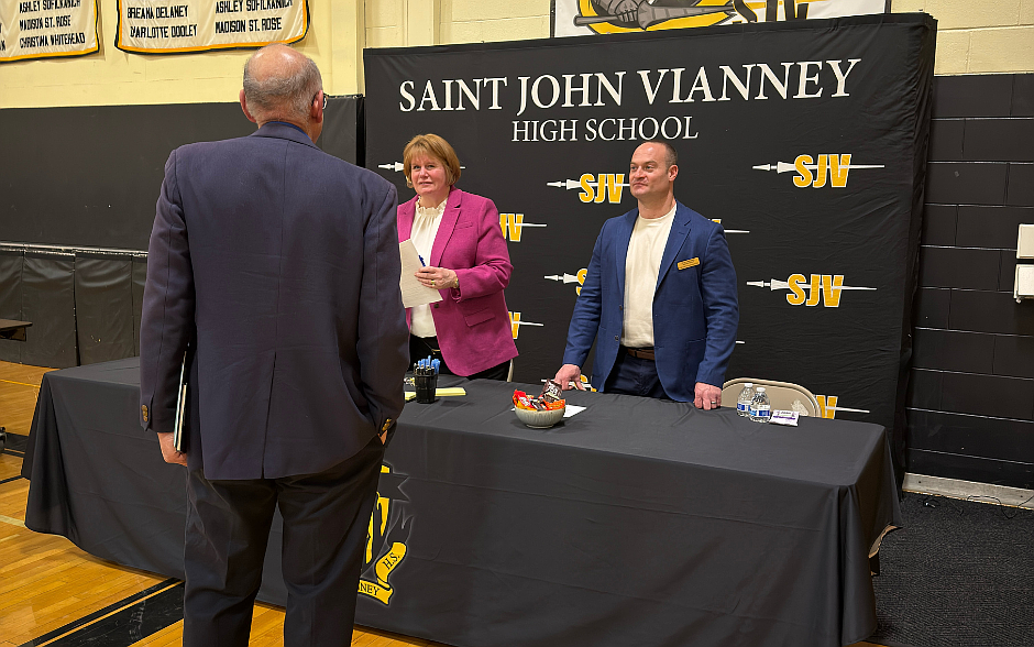 St. John Vianney High School principal, Margaret Kane and vice principal, Rich Lamberson meet with a prospective candidate at the April 8 job fair. B. Milecki photos.