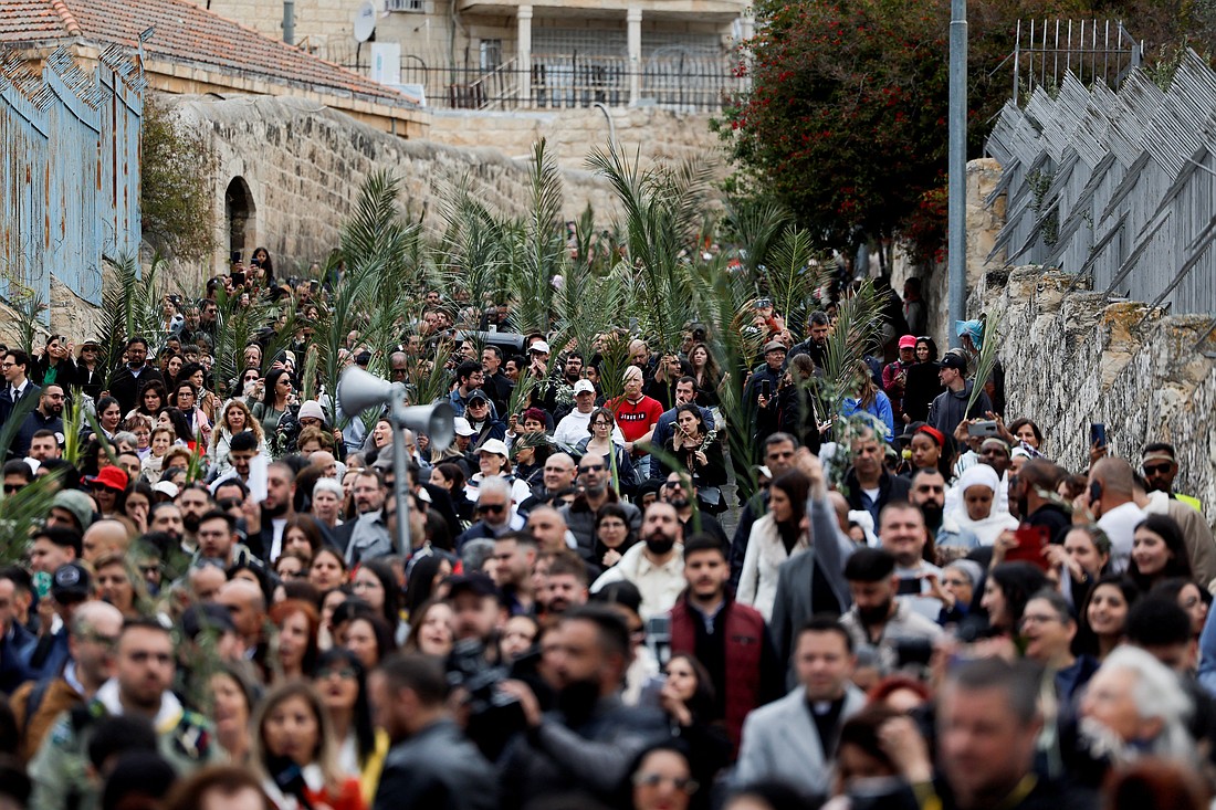 Christians wave palm and olive branches as they walk the traditional path that Jesus took on his last entry into Jerusalem during the Palm Sunday procession on the Mount of Olives April 13, 2025. (OSV News photo/Ammar Awad, Reuters)