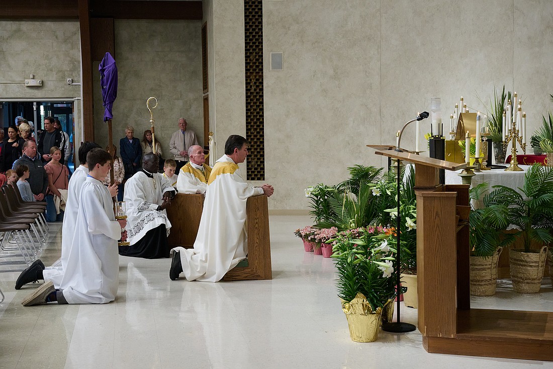 Bishop O'Connell and clergy from St. Aloysius Parish kneel before the Blessed Sacrament in the Chapel of Repose on Holy Thursday evening. Mike Ehrmann photos