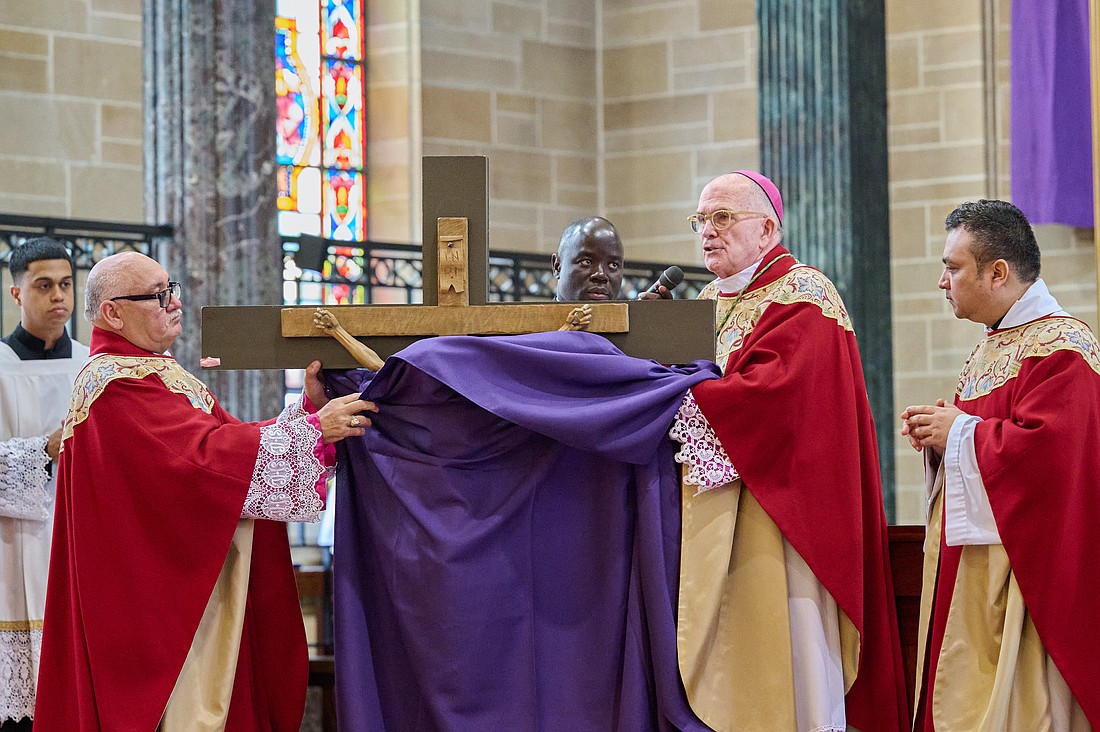 The purple drape covering the Crucifix is unveiled.