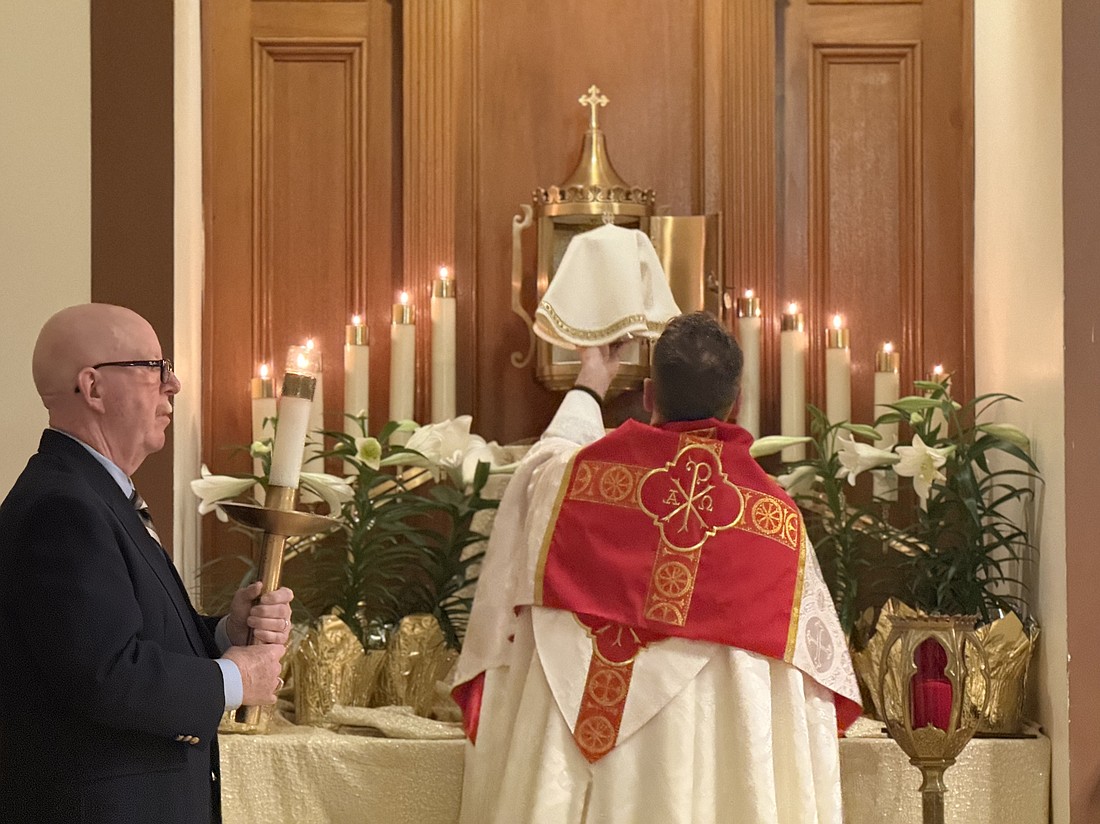 Father Wilson places the Blessed Sacrament in the Altar of Repose in Our Lady of Perpetual Help Parish, Maple Shade.
