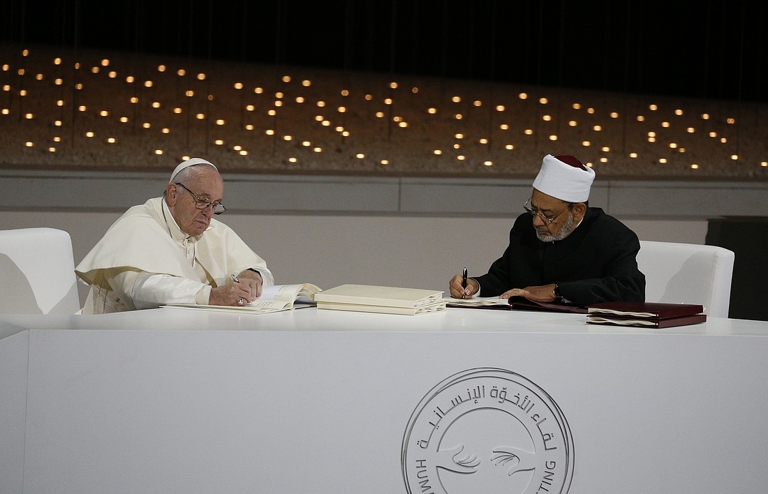 Pope Francis and Sheik Ahmad el-Tayeb, grand imam of Egypt's al-Azhar mosque and university, sign documents during an interreligious meeting at the Founder's Memorial in Abu Dhabi, United Arab Emirates, Feb. 4, 2019. (CNS photo/Paul Haring) See POPE-UAE-DIALOGUE Feb. 4, 2019.
