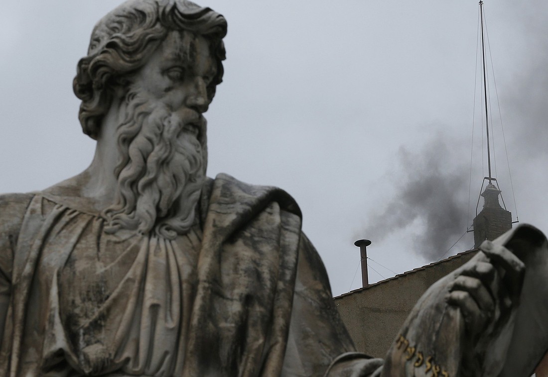 Black smoke emits from the chimney of the Sistine Chapel at the Vatican around noon March 13 to signify that a new pope was not elected. (CNS photo/Paul Haring) (March 13, 2013) See BLACK SMOKE March 13, 2013.