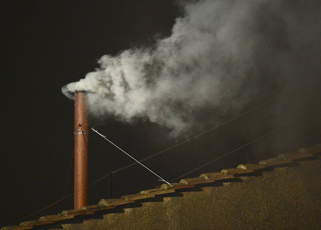 White smoke rises from the chimney above the Sistine Chapel in the Vatican, indicating a new pope has been elected, March 13, 2013. The conclave to elect a new pope met over two days before making a decision. (CNS photo/Dylan Martinez, Reuters)
