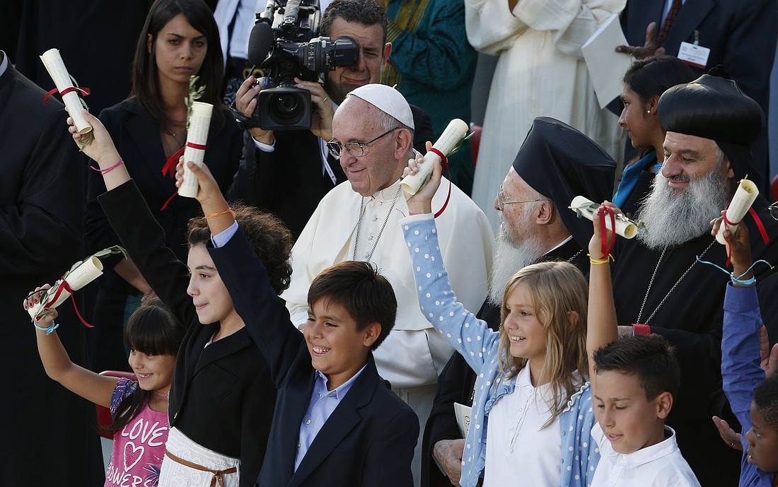 Pope Francis watches as children wave a peace document during an interfaith peace gathering outside the Basilica of St. Francis in Assisi, Italy, in this Sept. 20, 2016, file photo. Pope Francis, formerly Argentine Cardinal Jorge Mario Bergoglio, died April 21, 2025, at age 88. (CNS photo/Paul Haring).