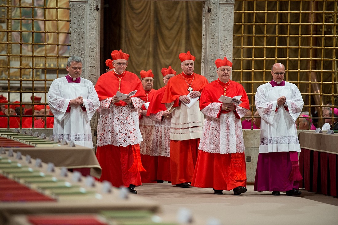 Cardinals enter the Sistine Chapel at the Vatican March 12, 2013, to elect a successor to Pope Benedict XVI. Pictured are: U.S. Cardinal James M. Harvey, archpriest of the Basilica of St. Paul Outside the Walls, left; U.S. Cardinal Edwin F. O'Brien, center; and Italian Cardinal Giuseppe Versaldi, right. (CNS photo/Vatican Media)