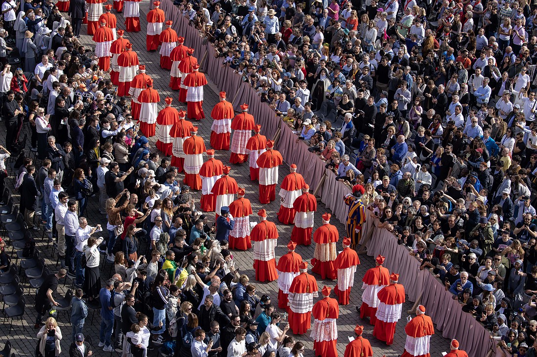 Cardinals walk through St. Peter's Square in a procession on their way into St. Peter's Basilica at the Vatican April 23, 2025, as the mortal remains of Pope Francis are prepared for public viewing and prayer. (CNS photo/Pablo Esparza)
