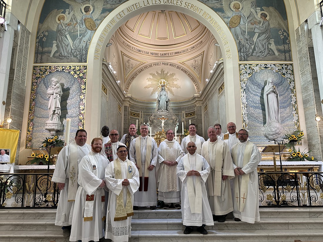 Bishop O'Connell and priests of the Diocese gather for a photo in the sanctuary of the Chapel of Our Lady of the Miraculous Medal in Paris, France. Staff photo