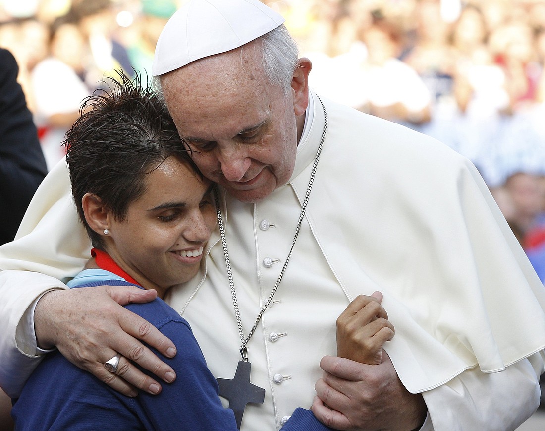 Pope Francis embraces a young woman during an encounter with youth in Cagliari, Sardinia, Sept. 22, 2013. Pope Francis, formerly Argentine Cardinal Jorge Mario Bergoglio, died April 21, 2025, at age 88. (CNS photo/Paul Haring)
