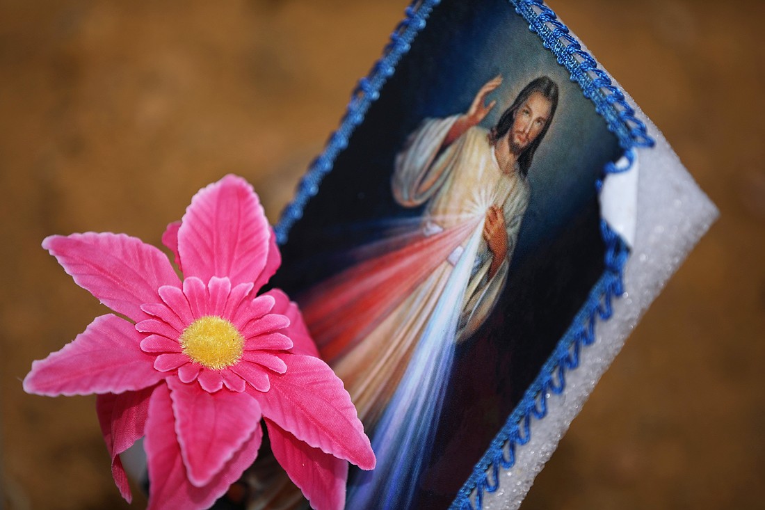 An image of the Divine Mercy is seen next to a flower at cemetery in Manaus, Brazil, June 17, 2020. It is celebrated April 27 this year. (OSV News photo/Bruno Kelly, Reuters)