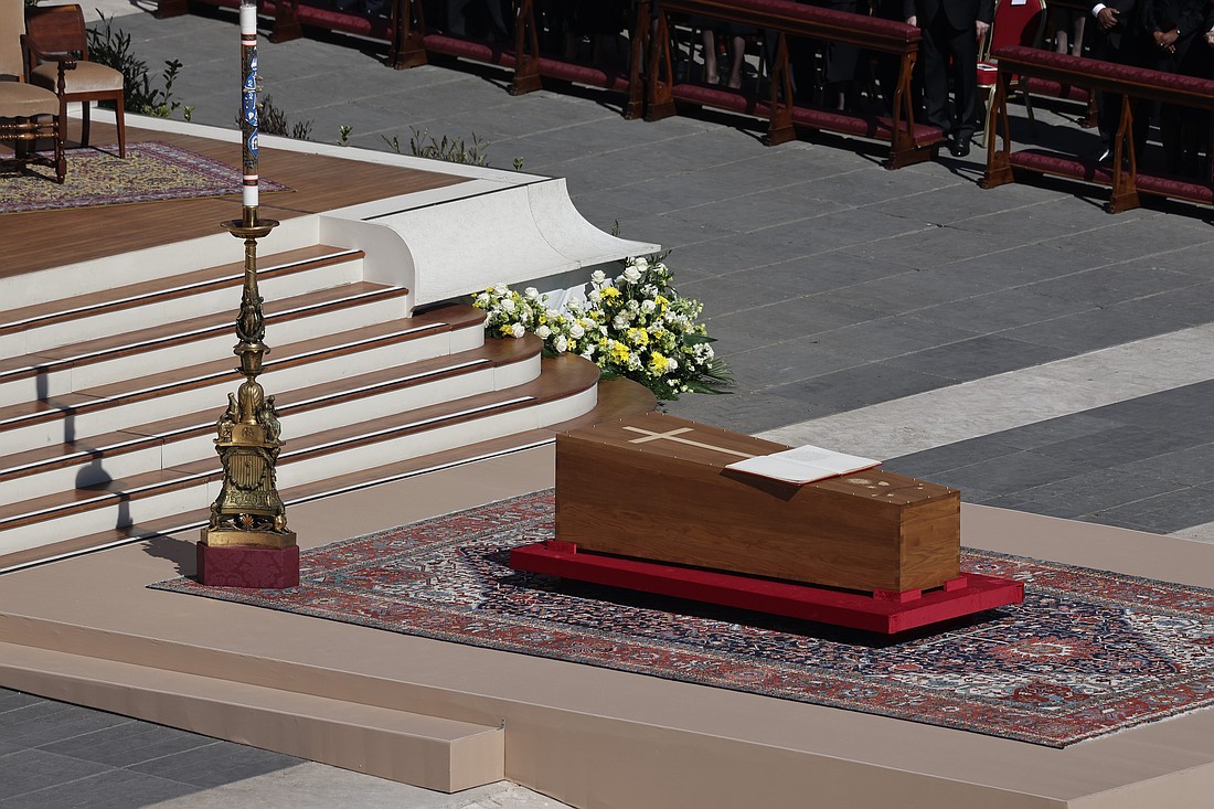 An open Book of the Gospels sits on top of the casket containing the mortal remains of Pope Francis at the beginning of his funeral Mass April 26, 2025, in St. Peter's Square at the Vatican. (CNS photo/Pablo Esparza)