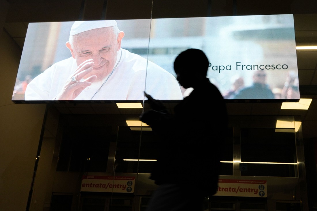 People walk past a digital billboard displaying an image of Pope Francis with the words "Ciao Papa Francesco" ("Goodbye Pope Francis") near the Basilica of St. Mary Major in Rome April 27, 2025. (CNS photo/Lola Gomez)