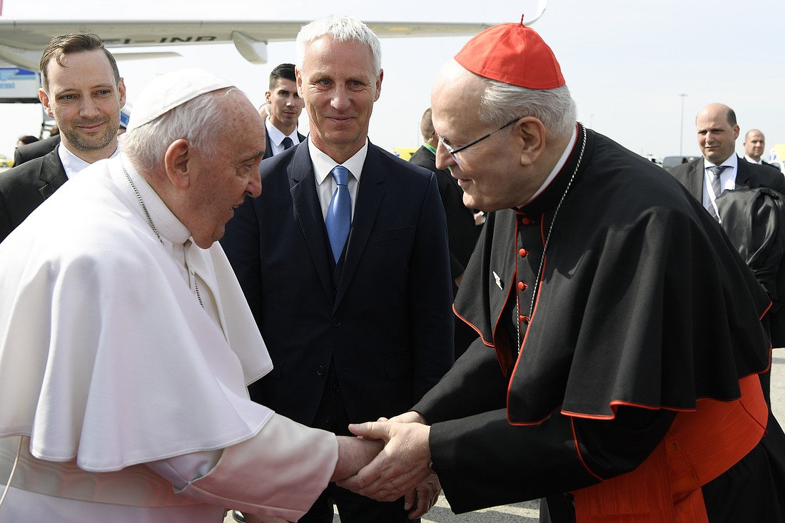 Pope Francis greets Cardinal Peter Erdo of Esztergom-Budapest as he arrives at the international airport in Budapest, Hungary, April 28, 2023. (CNS photo/Vatican Media)