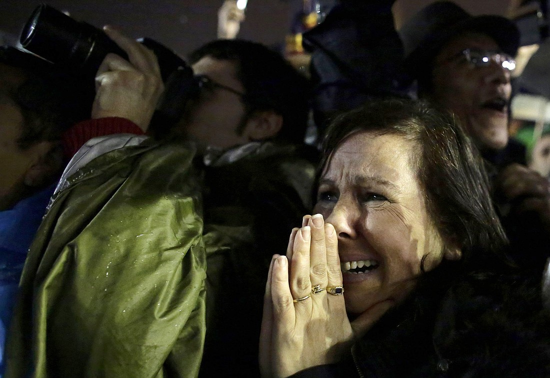 A woman in St. Peter's Square reacts as white smoke pours out from the Sistine Chapel chimney March 13, 2013, at the Vatican marking the election of Pope Francis. (OSV News photo/Kevin Coombs, Reuters)