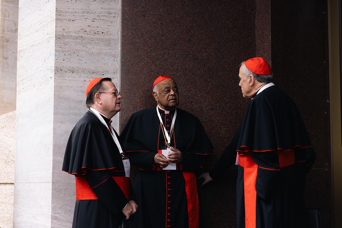 Cardinals Gérald C. Lacroix of Québec, Wilton D. Gregory, retired archbishop of Washington, and Daniel N. DiNardo, retired archbishop of Galveston-Houston, speak outside the Pontifical North American College in Rome May 5, 2025. The three cardinals will enter the conclave to elect a new pope May 7. (CNS photo/Kendall McLaren)