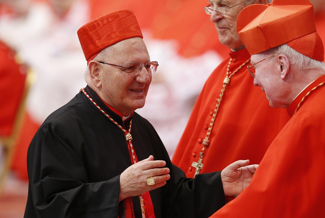 Cardinal Louis Sako, the Baghdad-based patriarch of the Chaldean Catholic Church, greets U.S. Cardinal J. Francis Stafford during a consistory in St. Peter's Basilica at the Vatican in this June 28, 2018, file photo. (CNS photo/Paul Haring)
