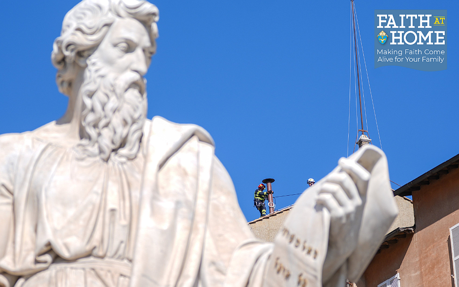 Seen behind the statue of St. Paul in St. Peter's Square, Vatican firefighters install a chimney on the roof of the Sistine Chapel May 2, 2025. Connected to a stove in the chapel where the ballots will be burned during the conclave to elect a new pope, the chimney will signal to the world whether a new pope has been elected. (CNS photo/Lola Gomez)