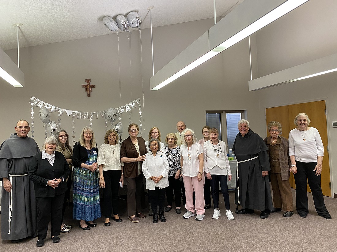Members of the Blessed Sacrament Fraternity gather for a group photo with Conventual Franciscan Father Noel Danielewicz, and Conventual Franciscan Brother James Moore, the fraternity’s former spiritual assistant, who attended the Mass. Kayla Latendresse photo
