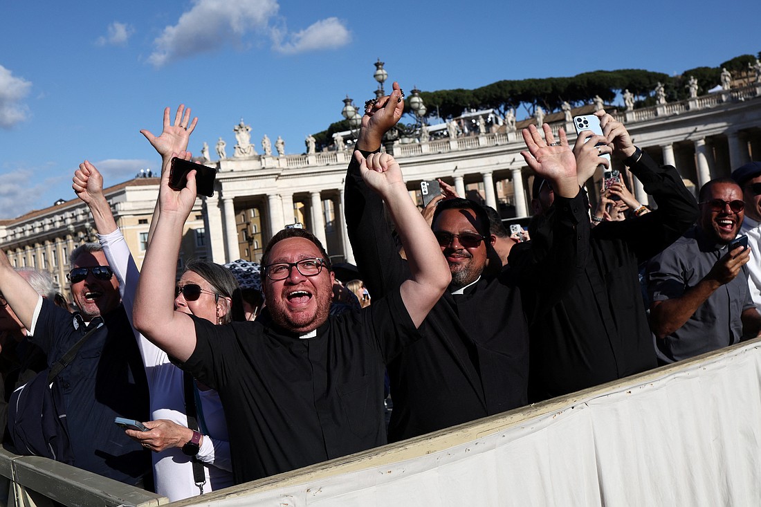 The crowd reacts in St. Peter's Square at the Vatican on the second day of the conclave as white smoke billows from the chimney indicating a new pope has been elected. (OSV News photo/Kevin Coombs, Reuters)