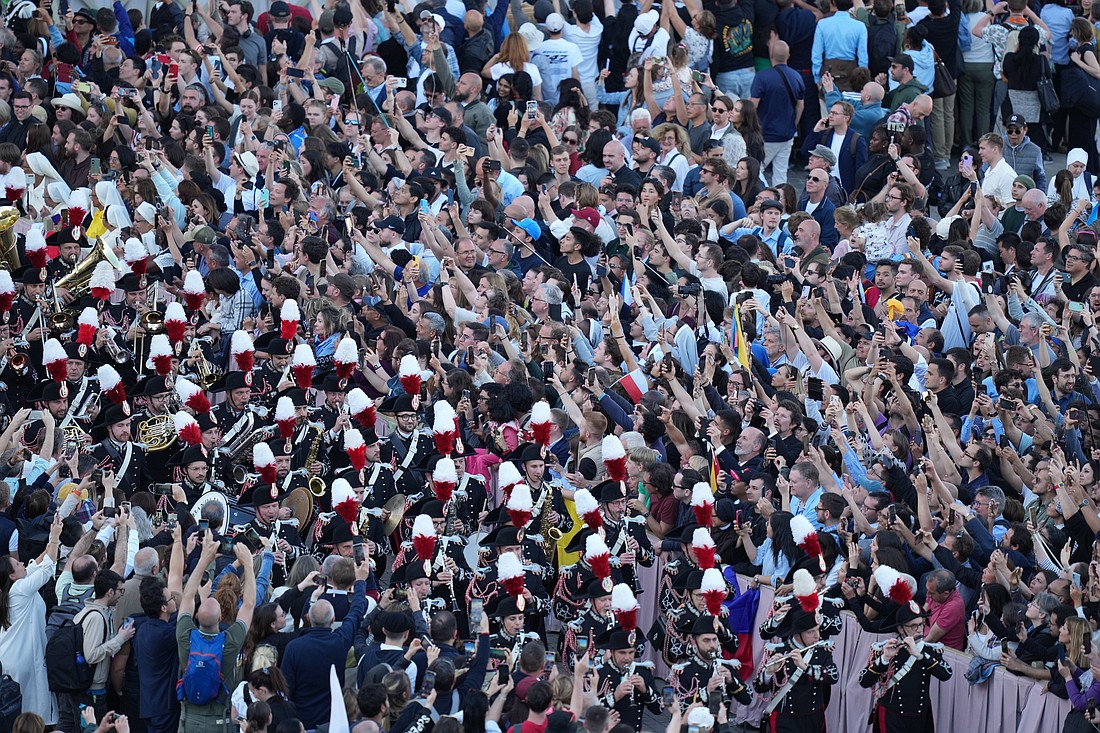 People cheer as the Italian military band processes into St. Peter's Square after white smoke billows from the chimney of the Sistine Chapel at the Vatican May 8, 2025, indicating the election of a new pope. (CNS photo/Kendall McLaren)