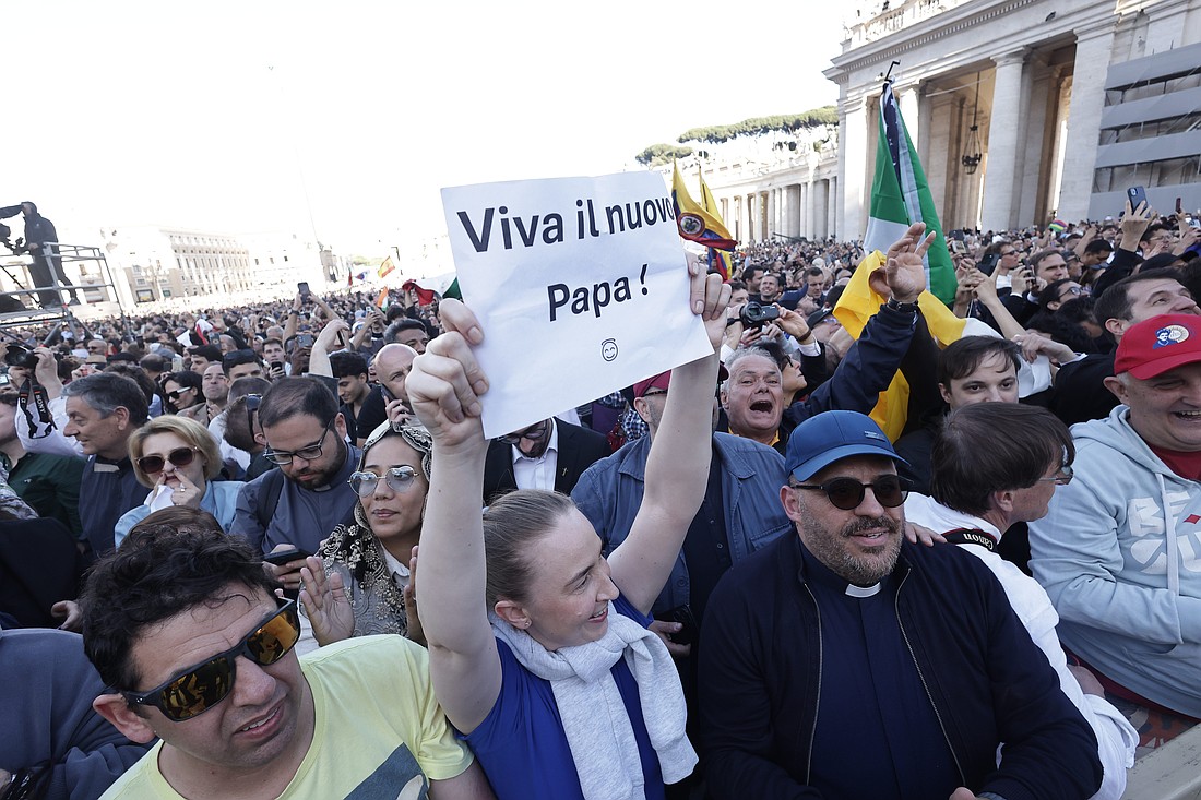 Crowds cheer in St. Peter's Square as white smoke billows from the chimney of the Sistine Chapel at the Vatican May 8, 2025, indicating the election of a new pope. (CNS photo/Pablo Esparza)