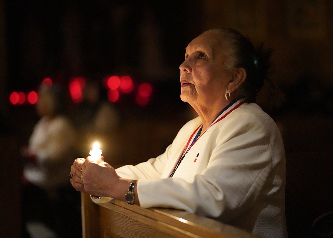 A woman prays during a Spanish-language candlelit Mass celebrated on the eve of the feast of the Presentation of the Lord, also known as Candlemas, at St. Joseph Church in the Staten Island borough of New York Feb. 1, 2025. (OSV News photo/Gregory A. Shemitz)